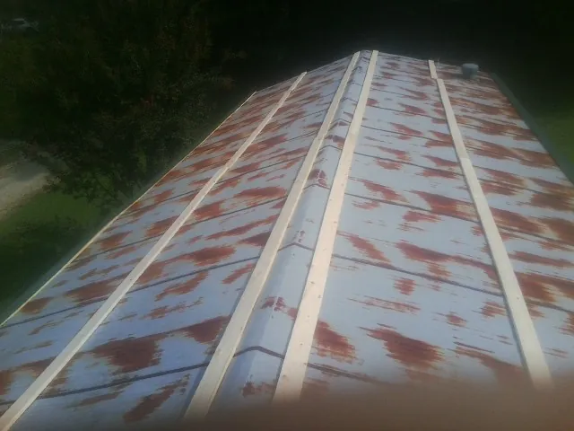 Rusted metal roof panels with new wood purlins before replacement — Storm Damage Roof Repair in Houlka by Roofing Brothers