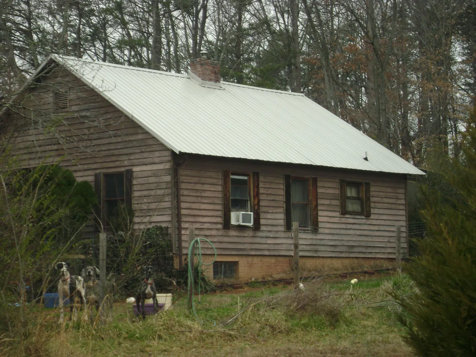 White metal roof on an old wood sided farmhouse, from a Metal Roof Installation job in Houlka